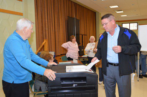 HE'S NOT ON THE BALLOT, but that didn't stop Town Moderator John Murphy from casting his vote in Precinct 4 on Tuesday. At left is election worker Ron Annand. (Bob Turosz Photo)