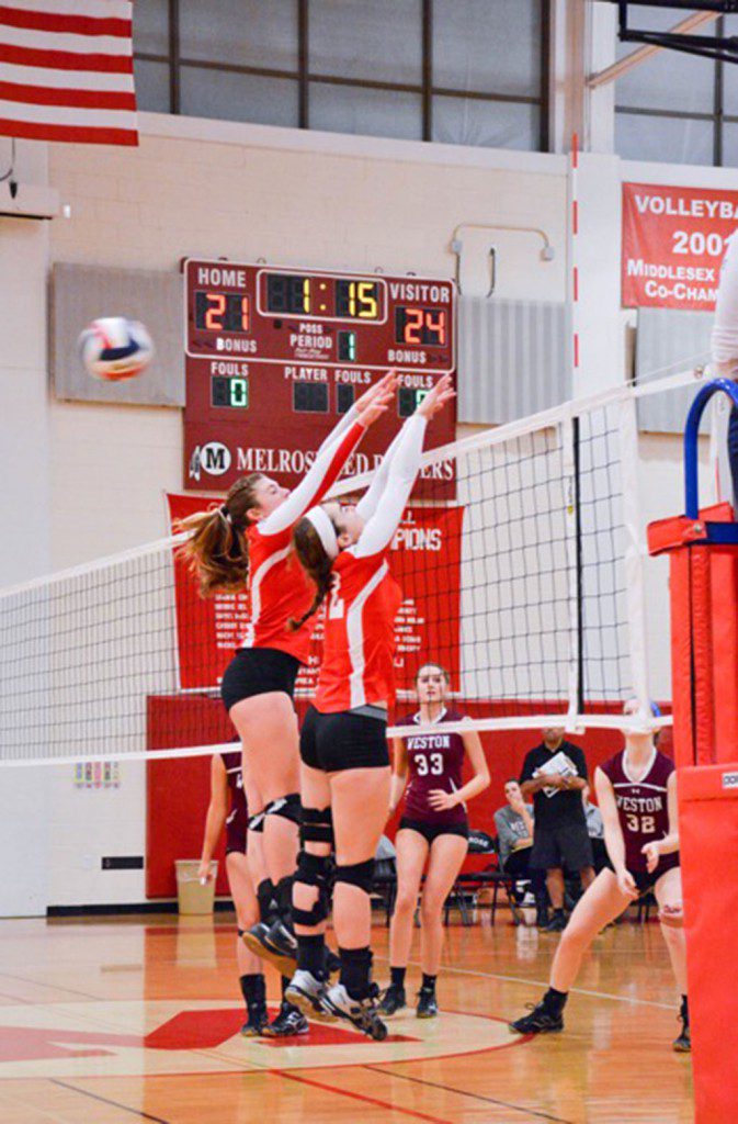 CROVO SISTERS Victoria (left) and Stephanie proved tough front row blocking but the Lady Raider volleyball team fell last Thursday in the sectional semifinals of the MIAA D2 North playoffs, 3-0 (Steve Karampalas photo) 