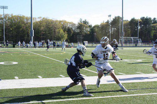 SENIOR CAPTAIN Trevor Caswell (12) fights for possession during the Pioneers’ 12-6 victory over Wilmington May 18.  (Dan Tomasello Photo)