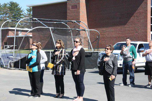 HEARTFELT respect was paid to Johnny “O’D” O’Donnell during the playing of the National Anthem by members of his family, including his mom, Deb O’Donnell (at left), sister-in-law Casey O’Donnell (second from right) and grandmother Mary Martin (at right). O’Donnell was a three-sport athlete at LHS. (Maureen Doherty Photo)