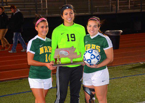 THE NRHS GIRLS SOCCER TEAM made it all to the MIAA Division 3 North Final game but fell to Newburyport in a shootout. Above, senior captains Marissa Zarella, Kat Hassapis and Kristina Copelas with the team's finalist trophy. (Transcript File Photo)