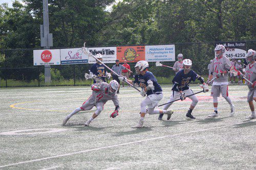 BRAEDAN LANGLOIS, a senior (#8), tries to dodge Malden Catholic defenders Brendan Maher (#10) and Jackson Hammersley (#20) as teammates Austin Collard (#4) and Henry Miller (#7) look on. The Warriors defeated Malden Catholic in the Div. 2 North quarterfinals on Saturday and are hoping for a semifinal win over rival Melrose tonight at Landrigan Field. (Keith Curtis Photo)